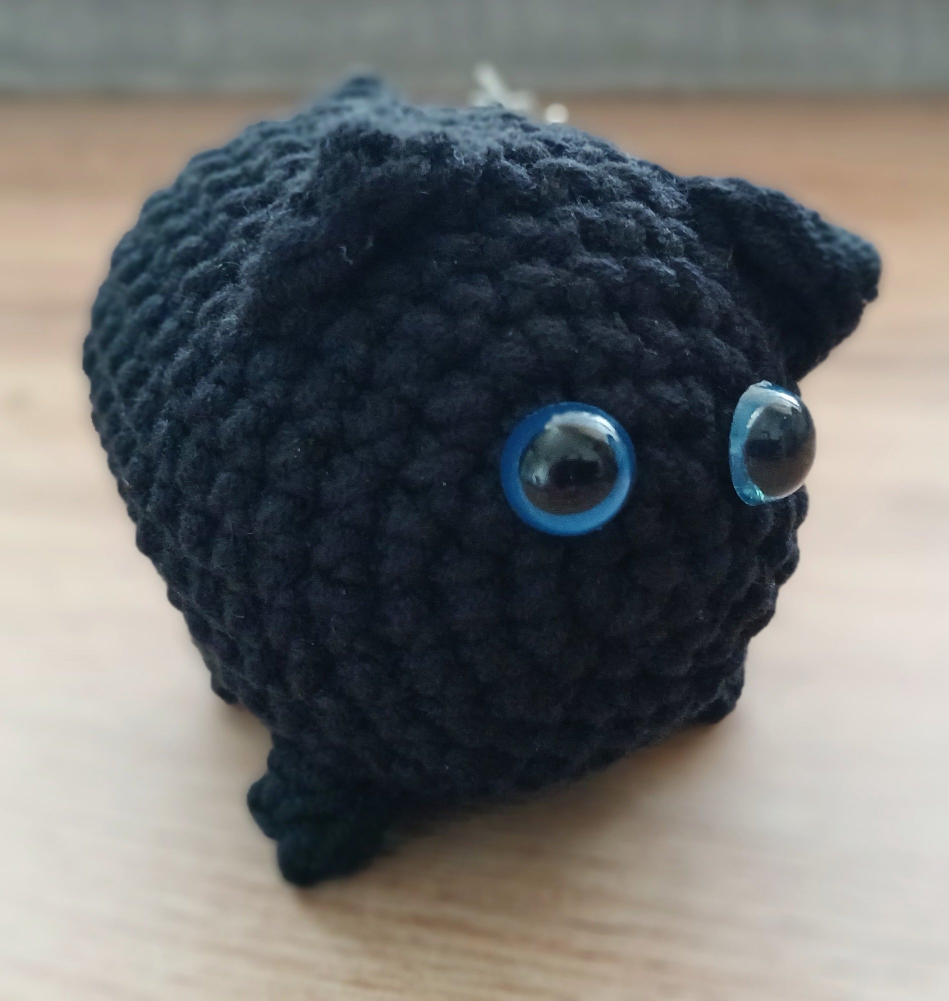 Black chunky cat keychain with blue eyes