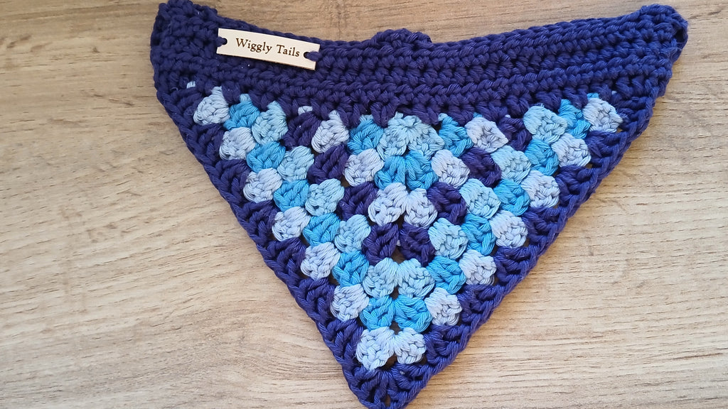 A flatlay of crochet dog bandana in multiple shades of blue