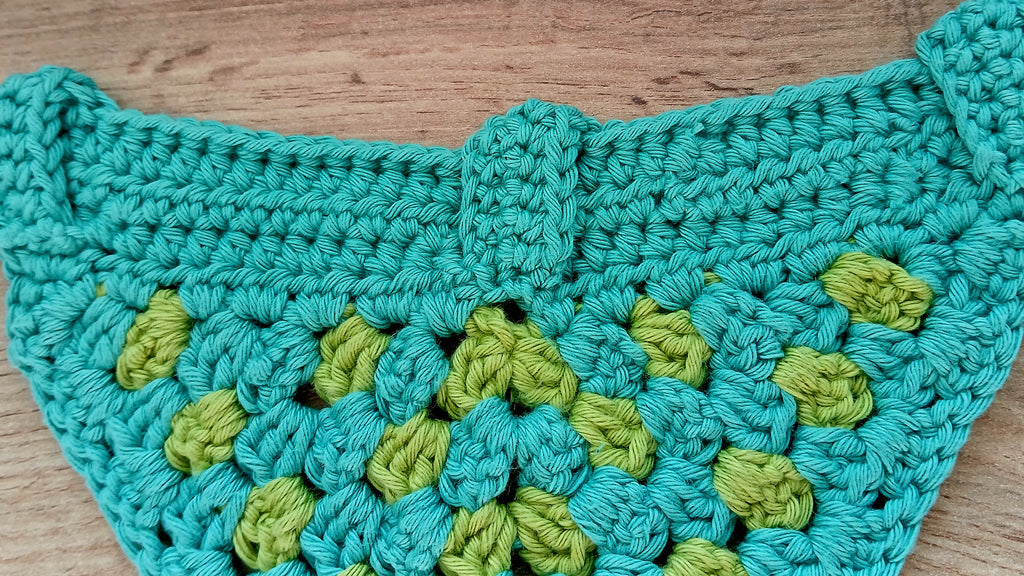 Teal and green crochet dog bandana - view from the back, showing buckles 