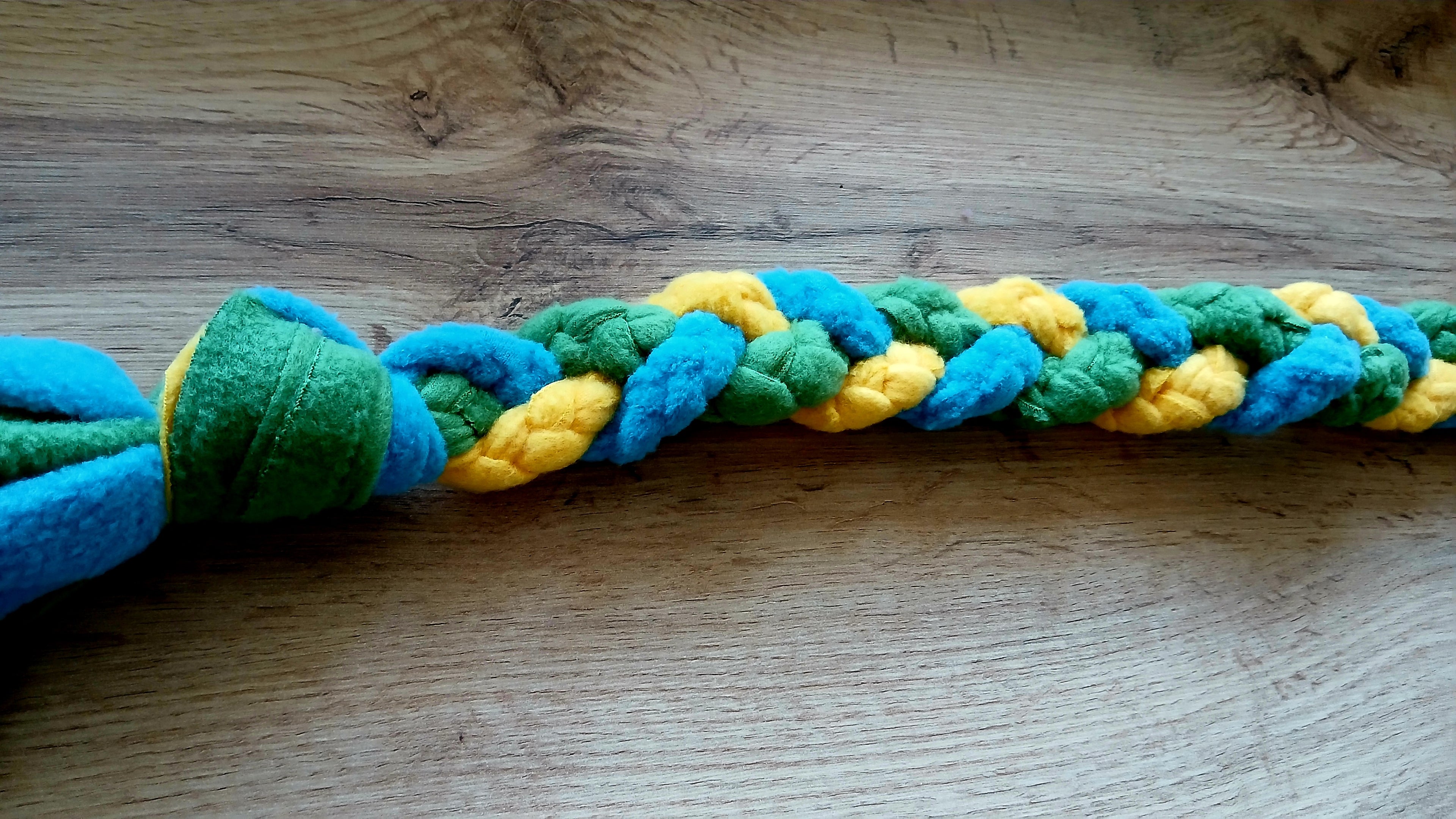 Fleece dog tug toy in green, blue and yellow