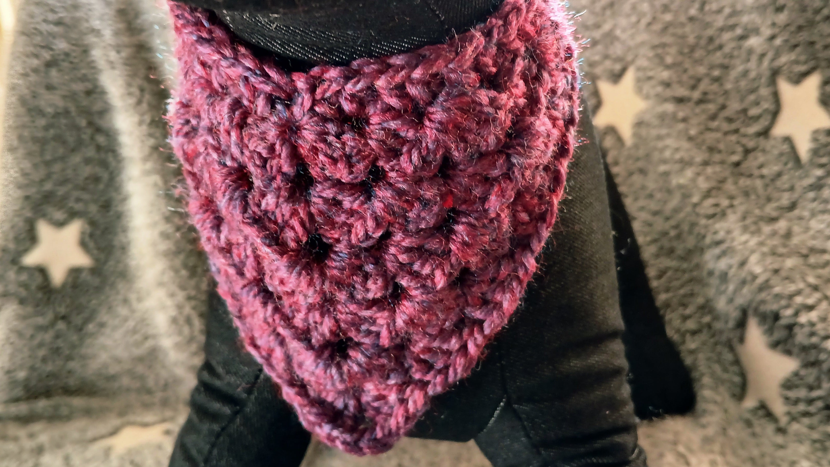 A close up of a burgundy dog bandana on a dog mannequin 