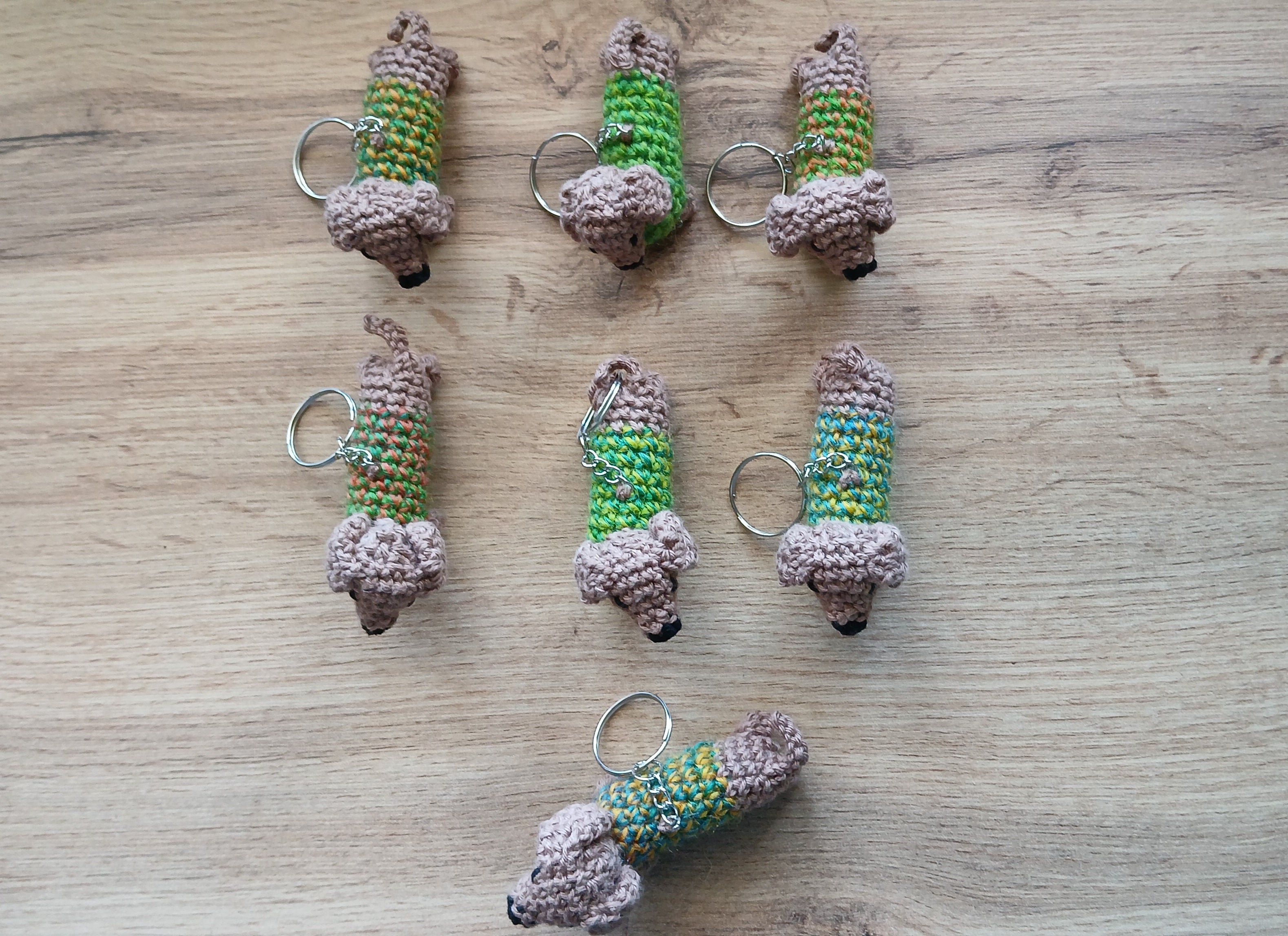Dachshunds wearing green sweaters in a form of keychain 