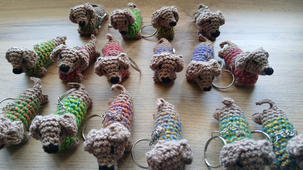 Dachshunds with colorful sweaters in a form of keychains 