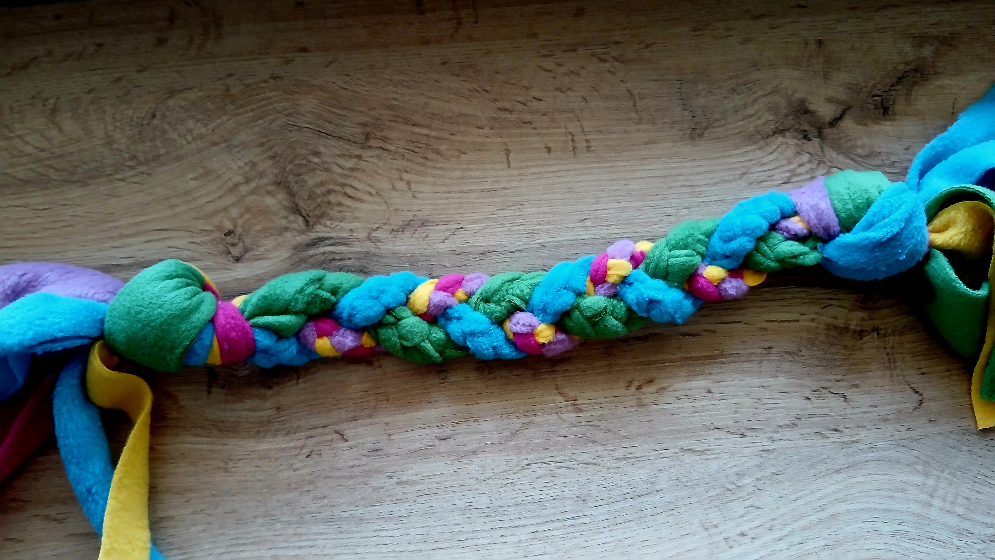 Fleece tug toy in multiple colors, mainly green and blue