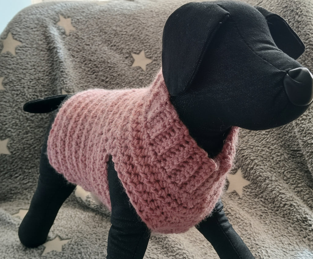 A crochet dog sweater on a dog mannequin, showing front of the pullover at a slight angle 