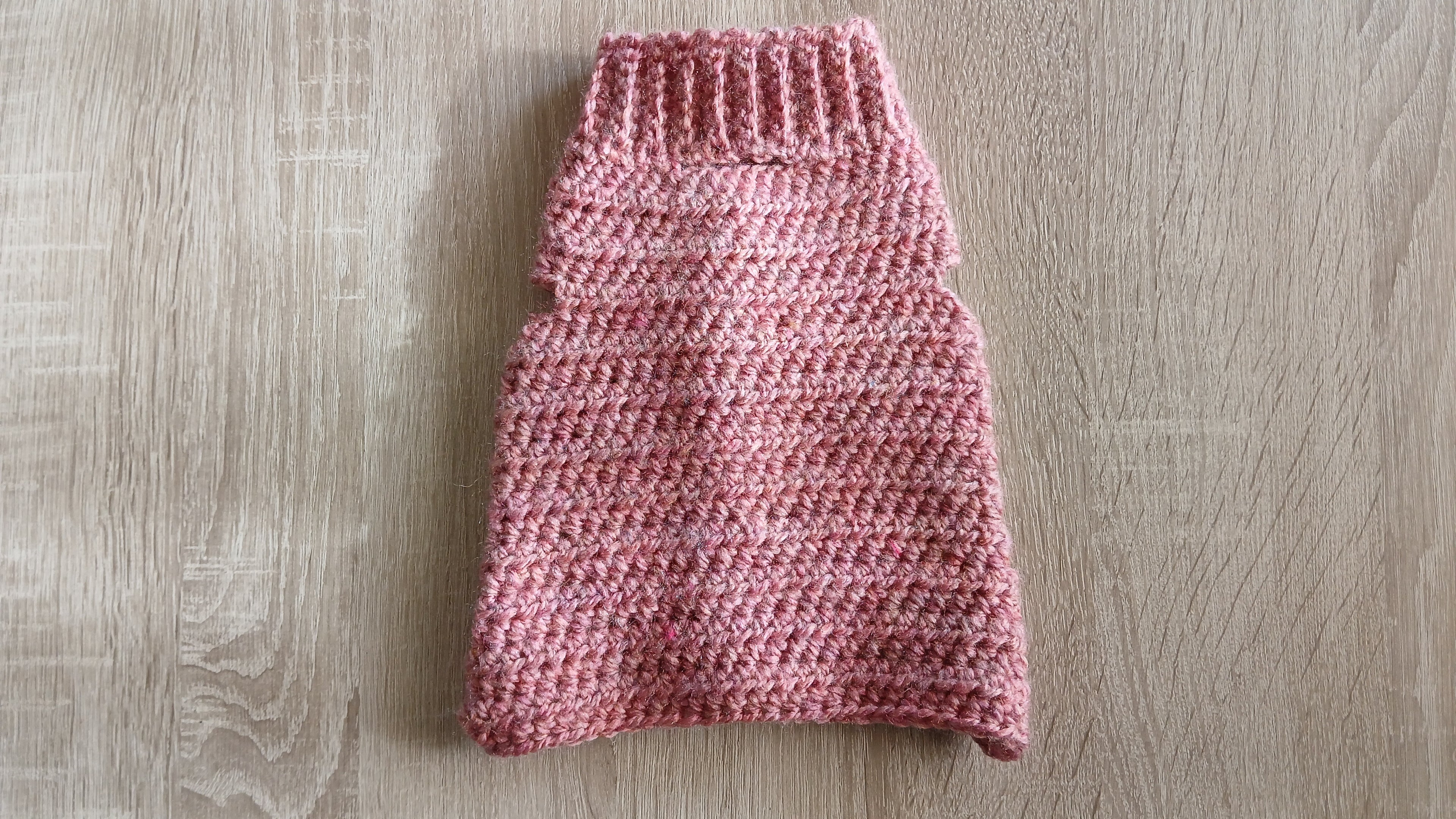 A flatlay of a dog sweater, showing the back