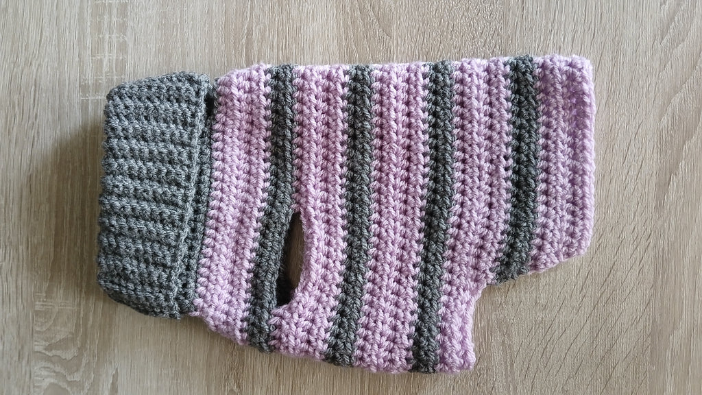 A flatlay showing side of grey lilac dog sweater