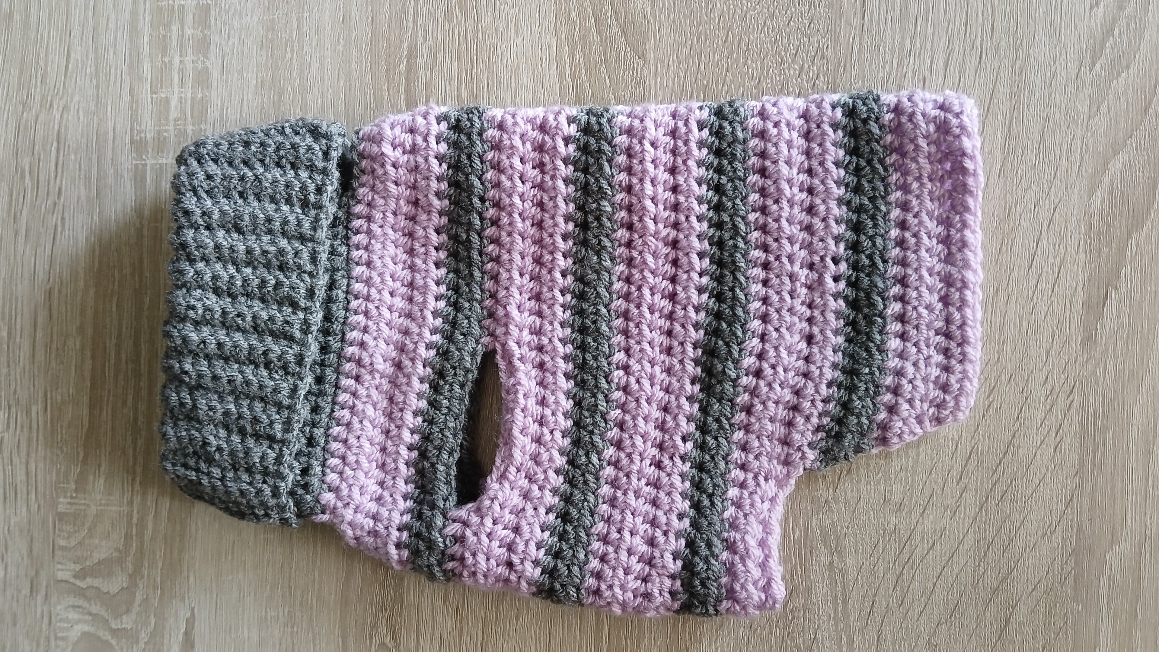 A flatlay showing side of grey lilac dog sweater