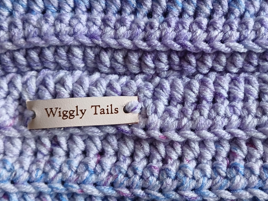 Close up of a lavender ombre crochet dog snood 