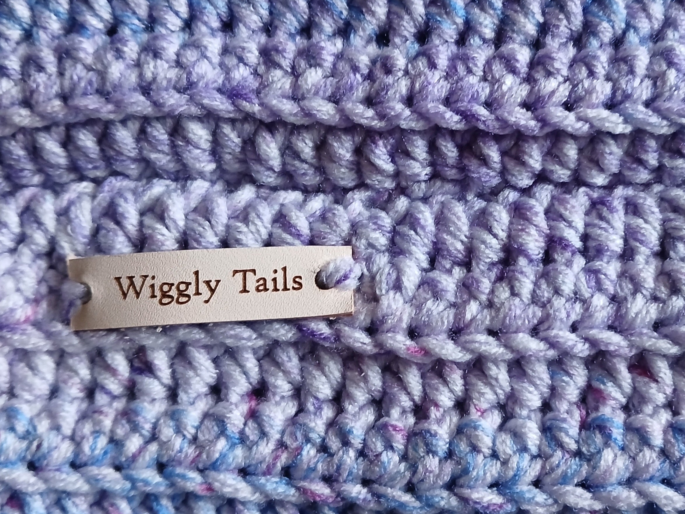 Close up of a lavender ombre crochet dog snood 