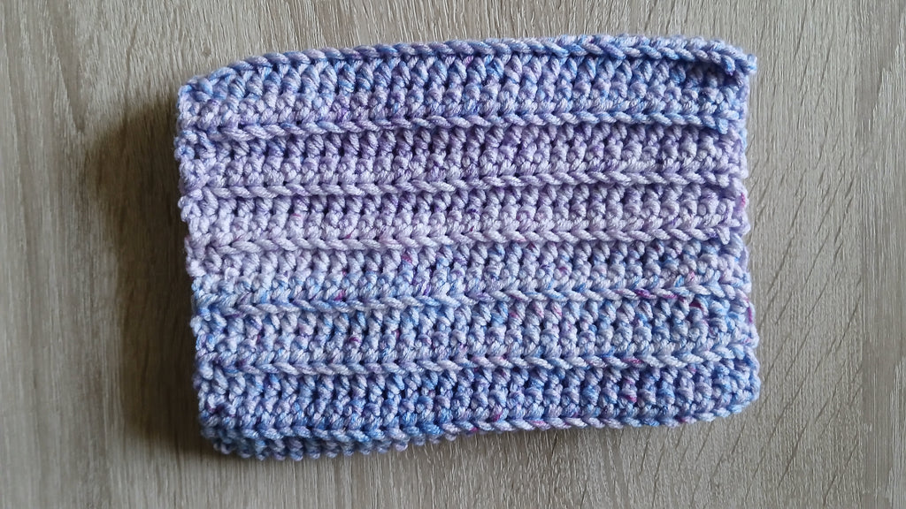 Flatlay of lavender ombre crochet dog snood 