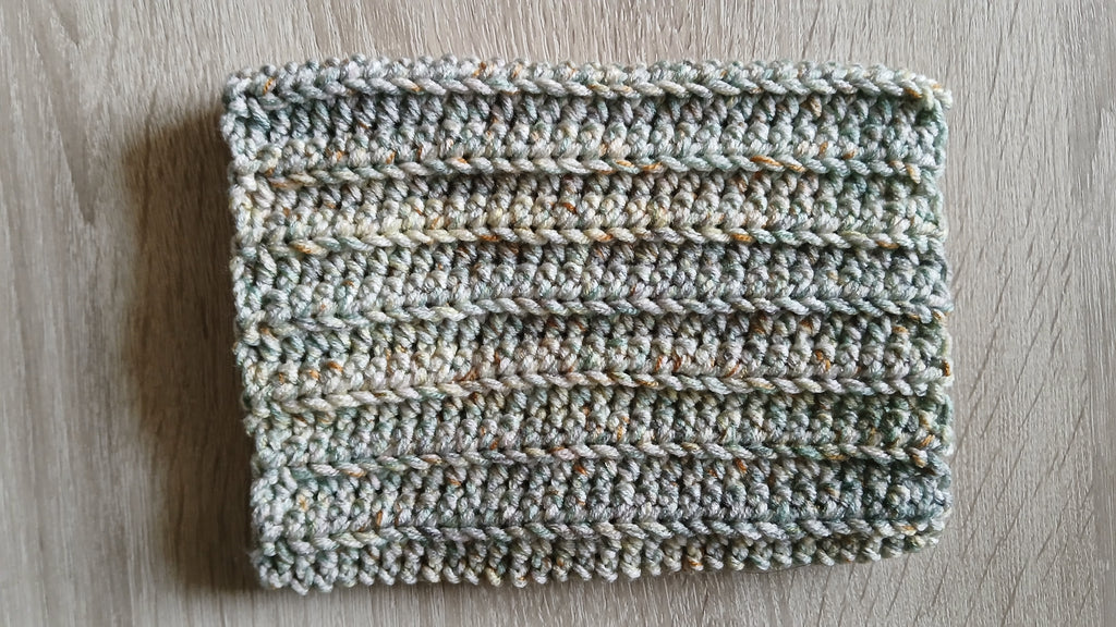 A flatlay of a olive green dog snood