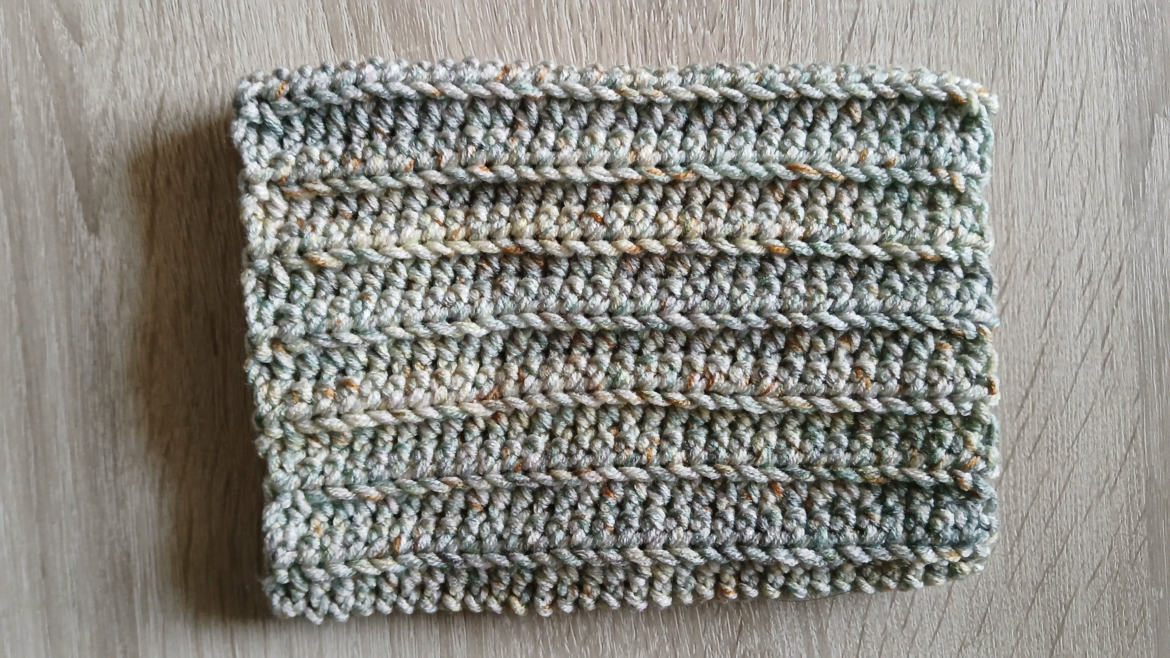 A flatlay of a olive green dog snood