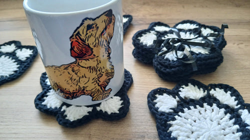Set of paw print coasters with a mug