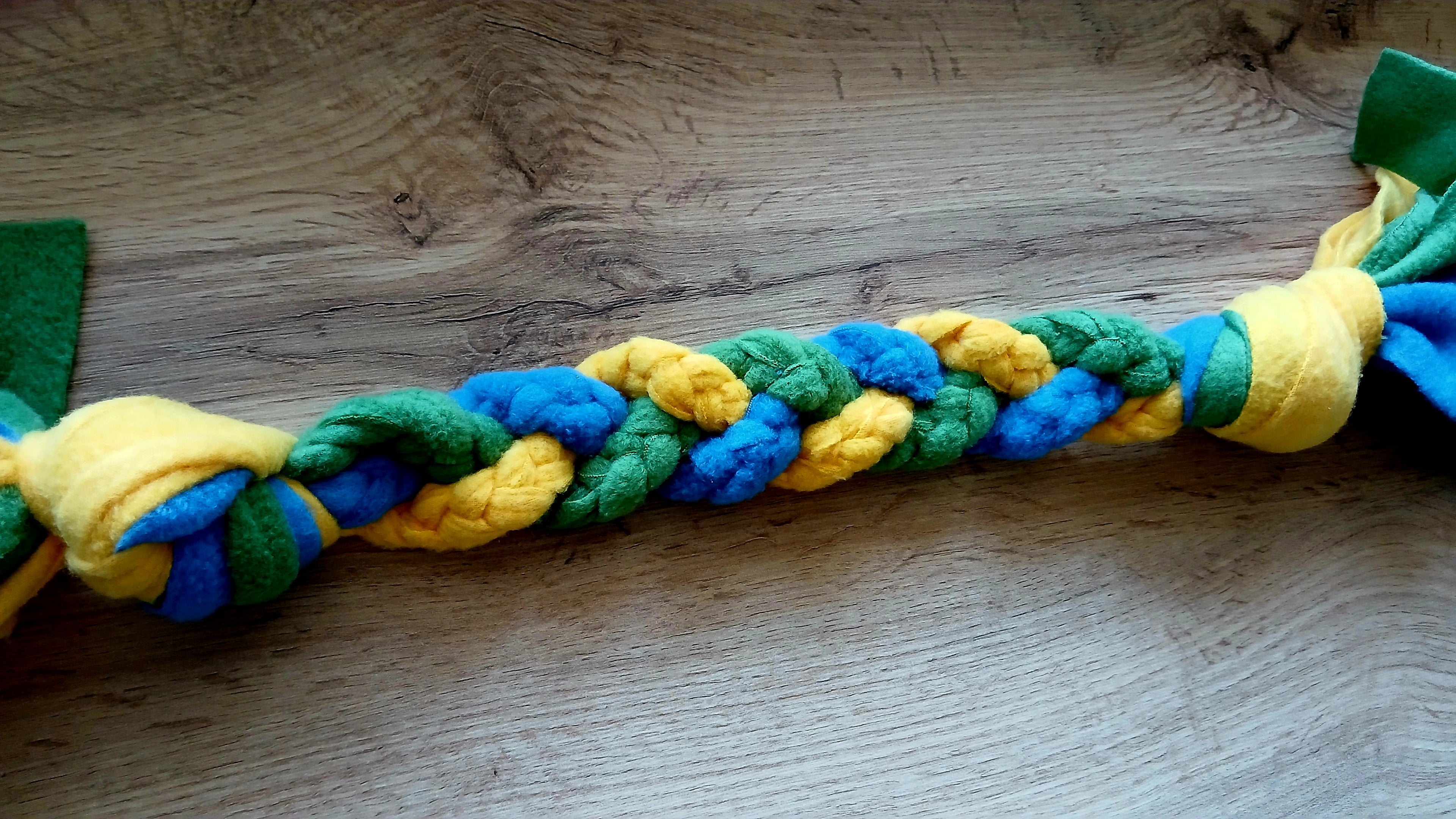 Fleece dog tug toy in yellow, blue and green