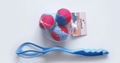 three blue and red splash ball in a mesh net with a blue launcher handle
