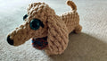 dachsund plushie with a crochet bandana in blue and orange